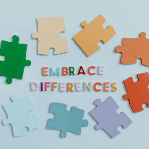 Colorful puzzle pieces surrounding 'embrace differences' text, symbolizing diversity and unity.